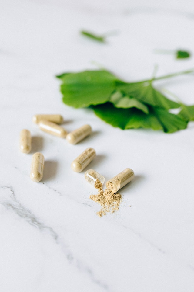 an opened capsule of kratom